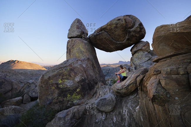 Woman resting on Texas mountain