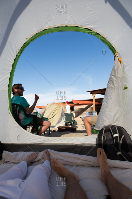 Young adult friends in and outside tent, Anza-Borrego Desert State Park, California, USA