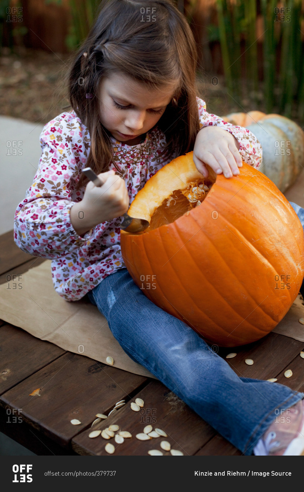 Girl carving a Jack O'Lantern for Halloween