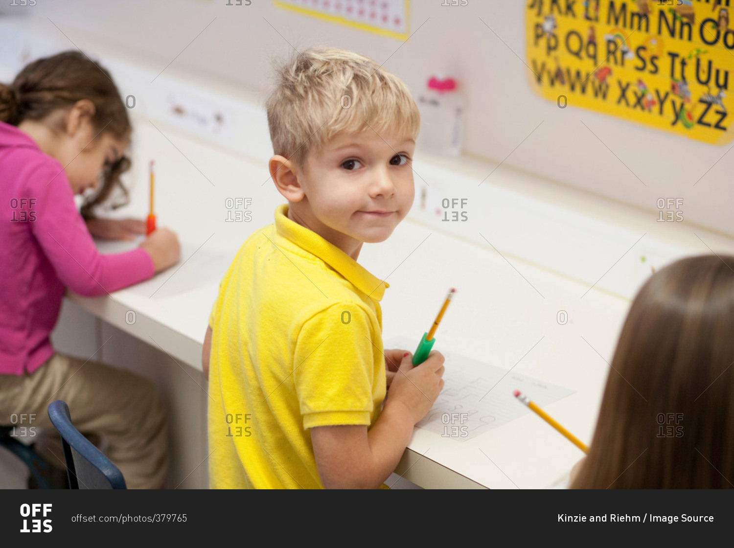 Toddlers writing in a preschool class stock photo - OFFSET