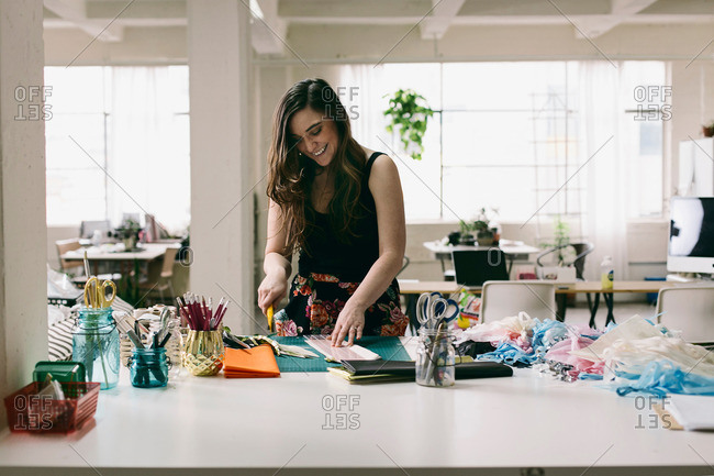 Female textile designer preparing textiles in design studio
