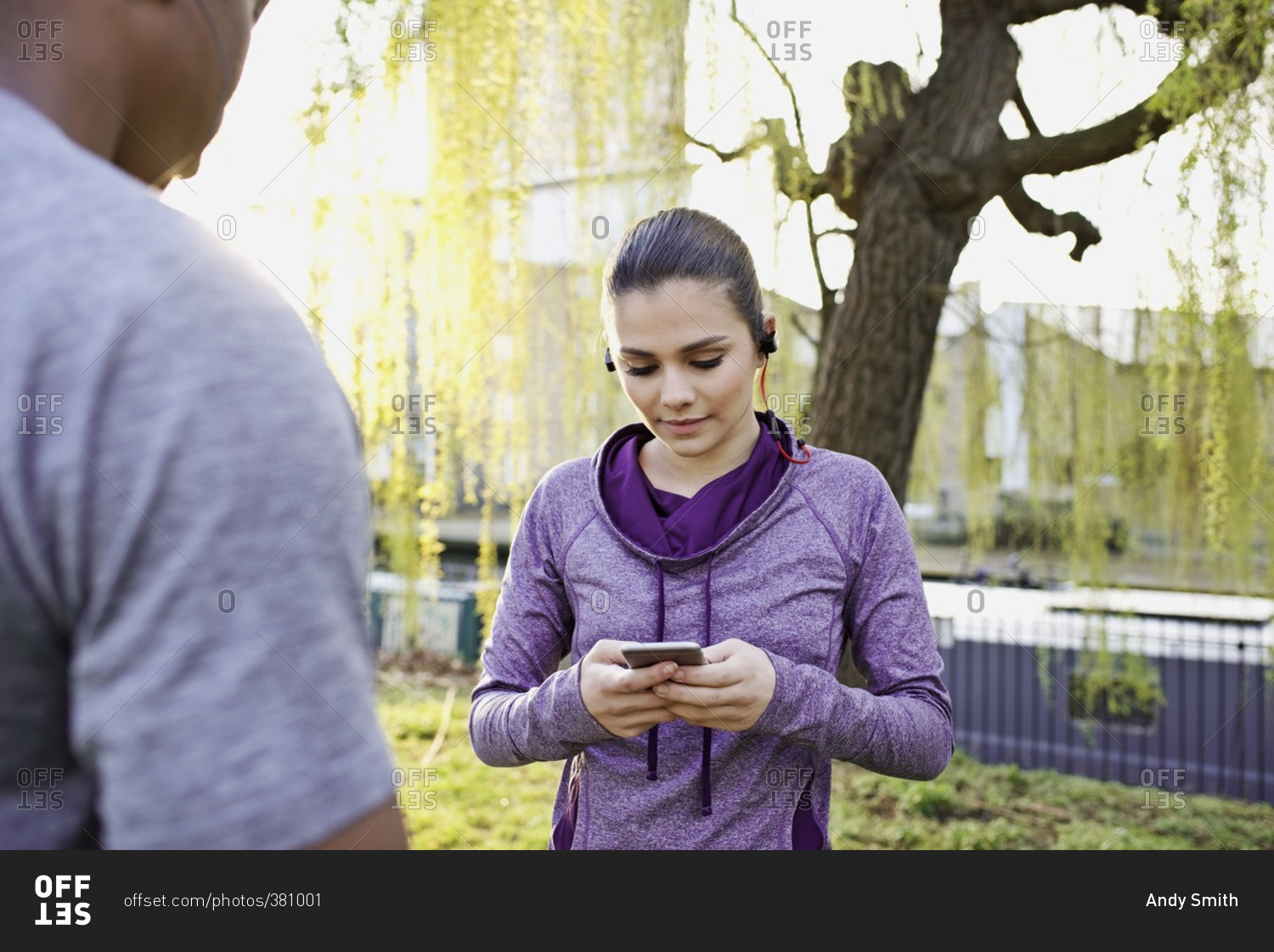 Woman checking her smartphone during a workout