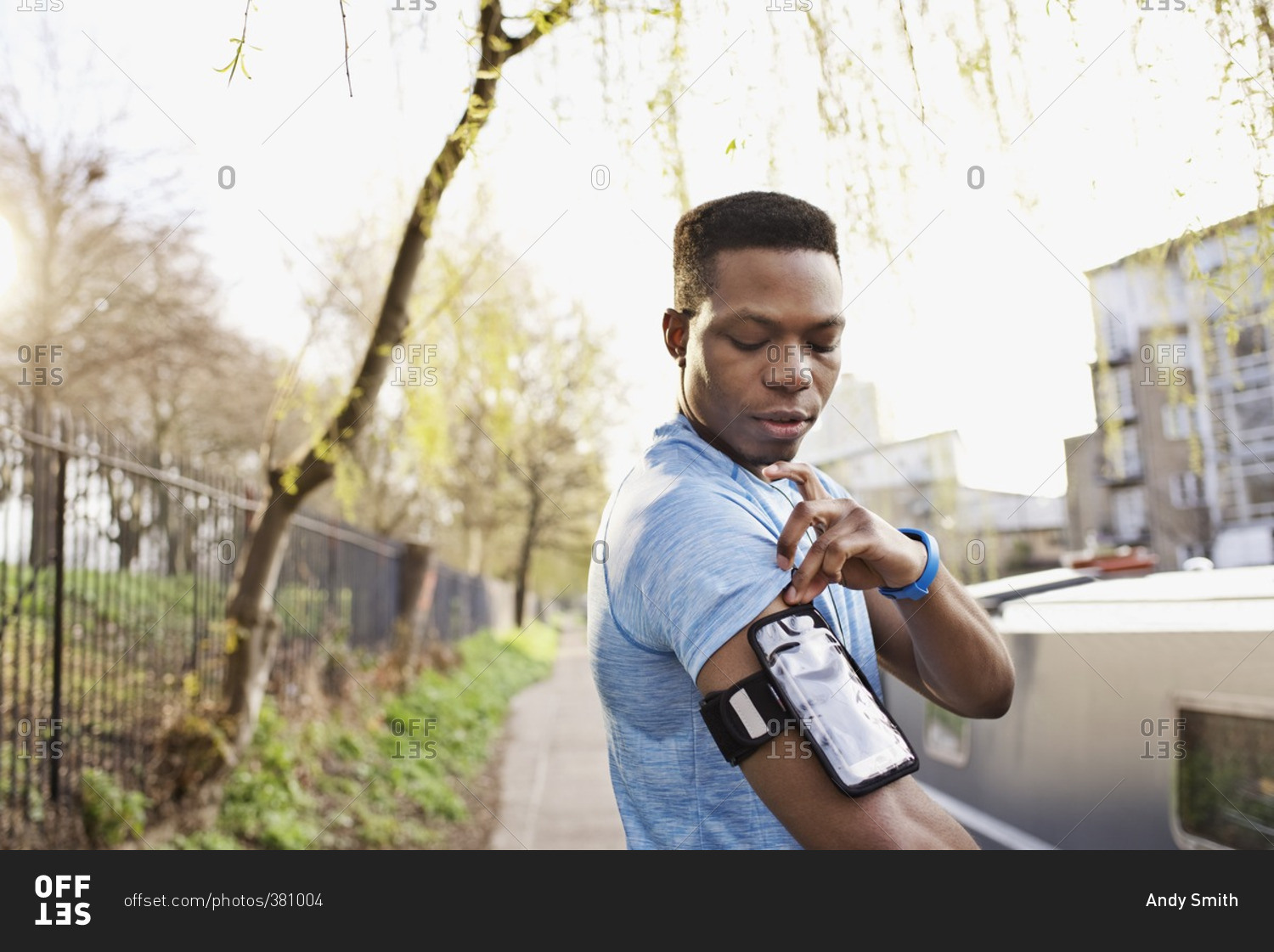 Portrait of an African American man adjusting a digital music player before a workout