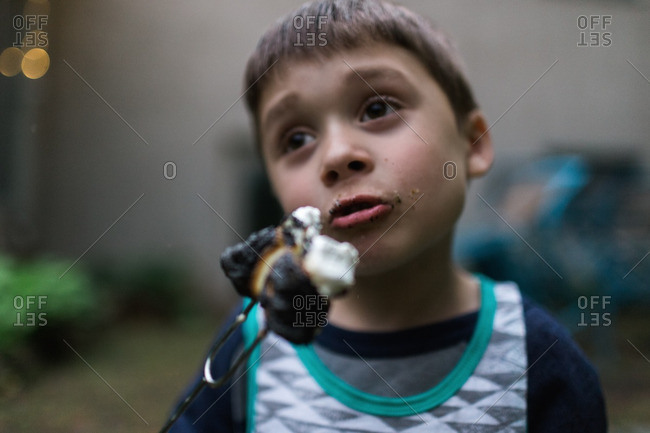 Little boy holding a burnt marshmallow