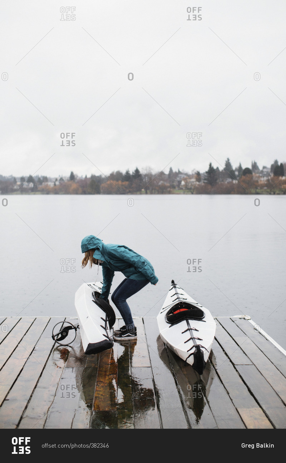 Woman with kayaks on dock