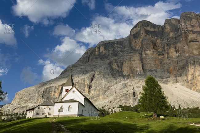 Church of the Holy Cross with Sas dla Crusc mountain, Fanes Sennes Braies Nature Park, Valley, Trentino Alto Adige, Italy stock photo OFFSET