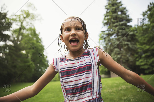 Girl playing outside in the rain