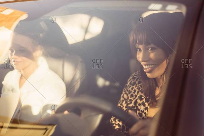 Woman behind wheel with friend