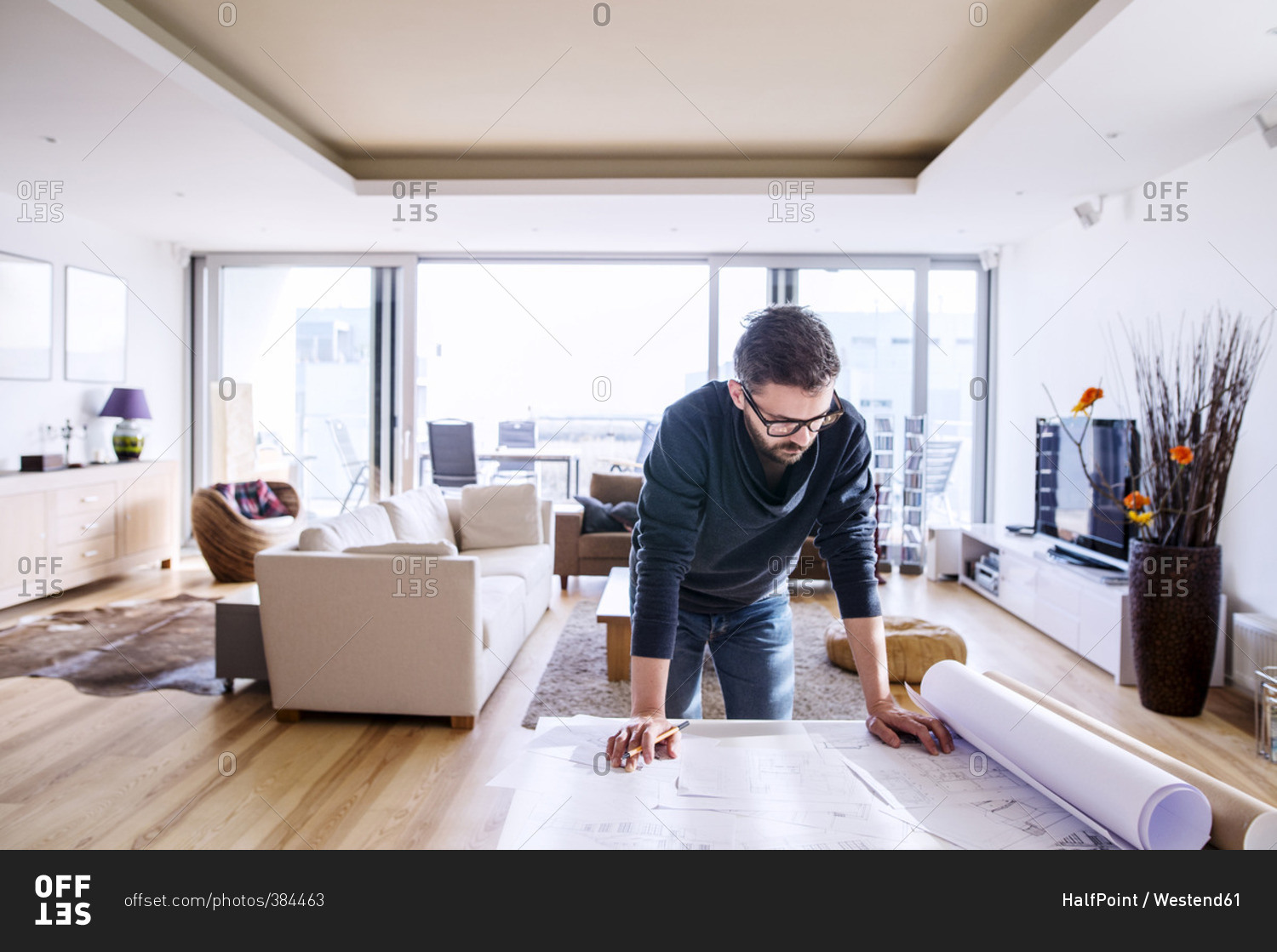 Man looking at architectural plans at home