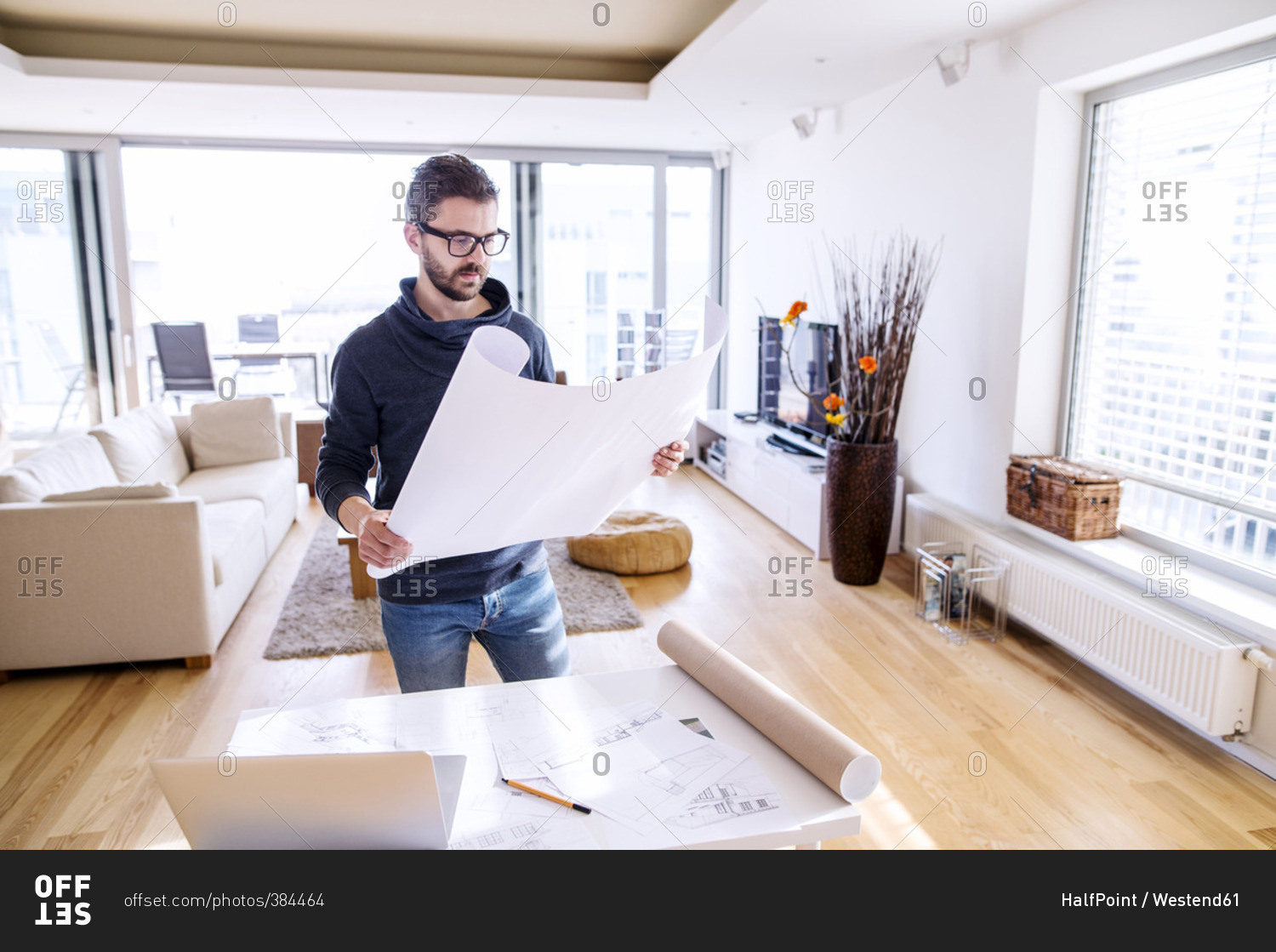 Man reviewing architectural plans at home