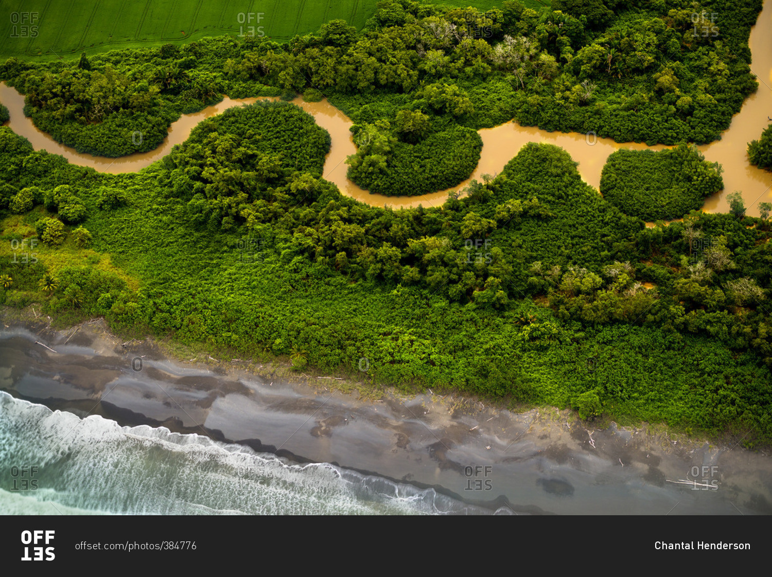 Aerial view of muddy river winding along coast stock photo OFFSET