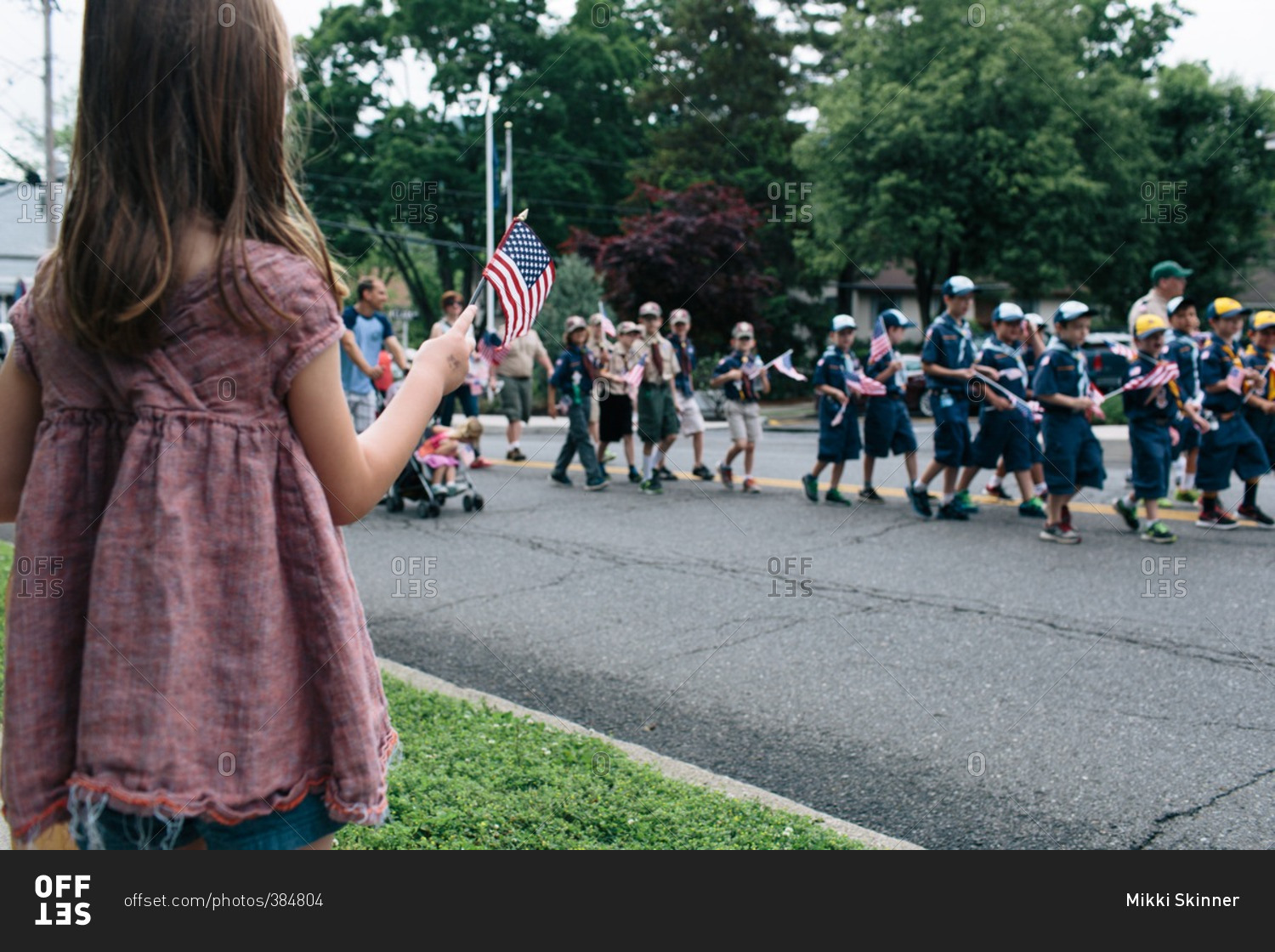 Girl waving American flag at a parade