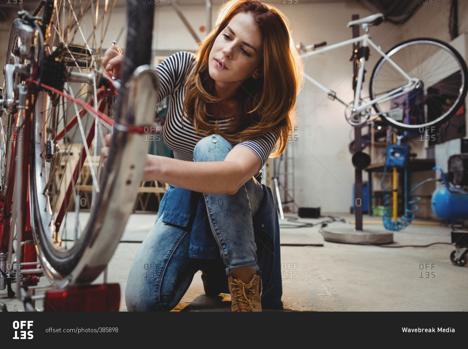 Woman looking at a bicycle in a workshop