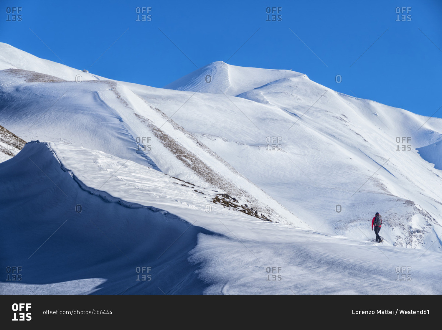 Hiker on mountain Vettore in winter
