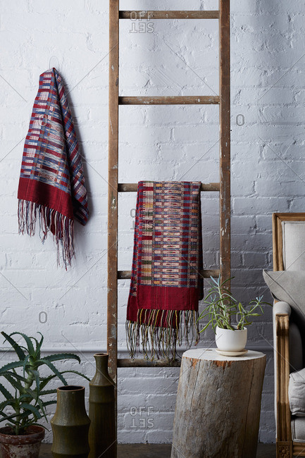 Wooden ladder with hand woven blankets