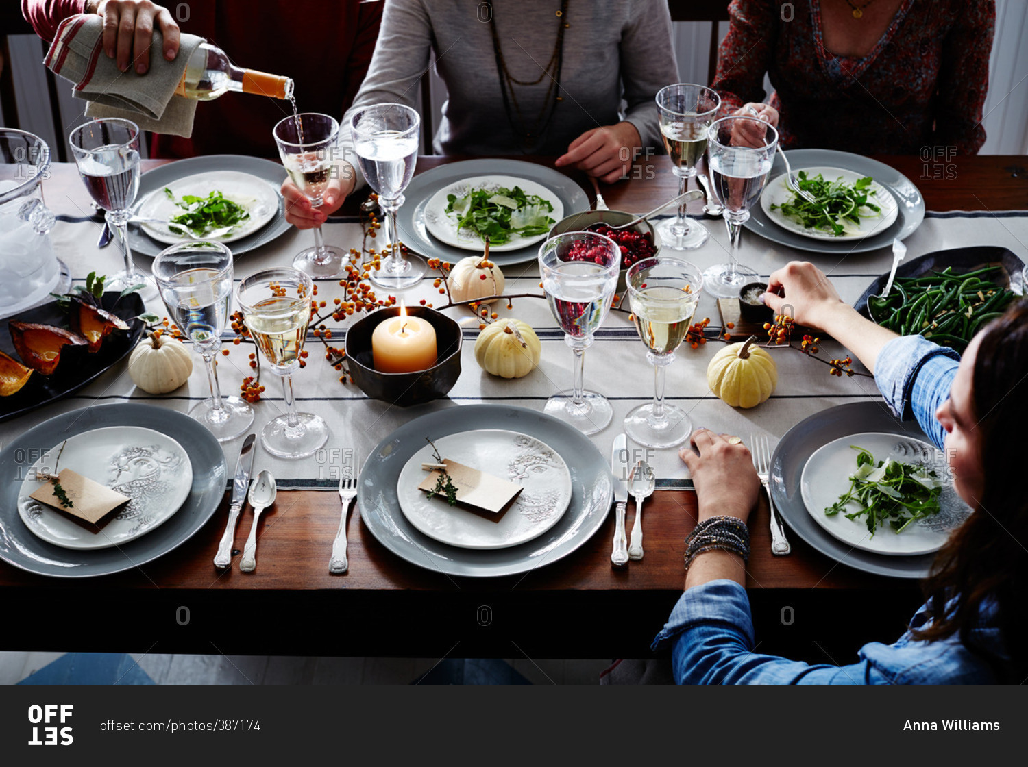 Adults gathered around table for Thanksgiving dinner
