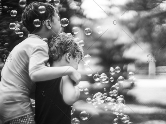 Boys playing with bubbles