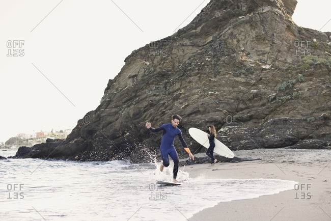Surfers riding near the shore