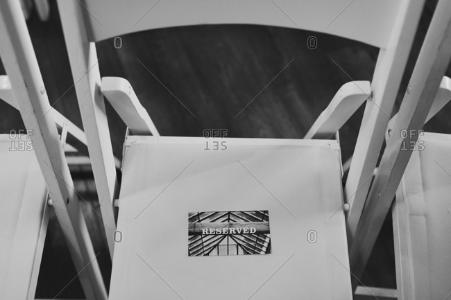 Close-up of a chair reserved for a wedding guest