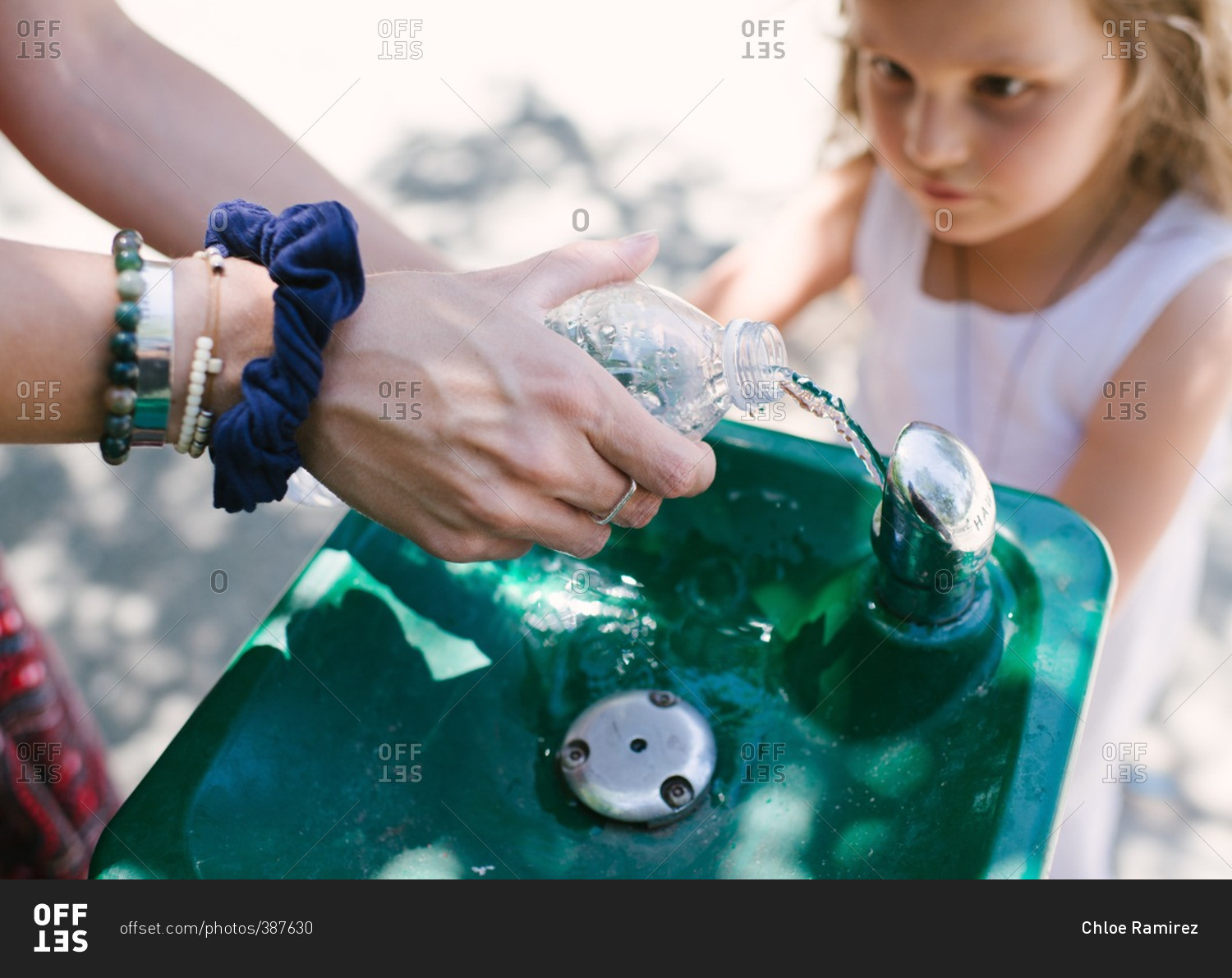 Woman filling up water bottle at a fountain
