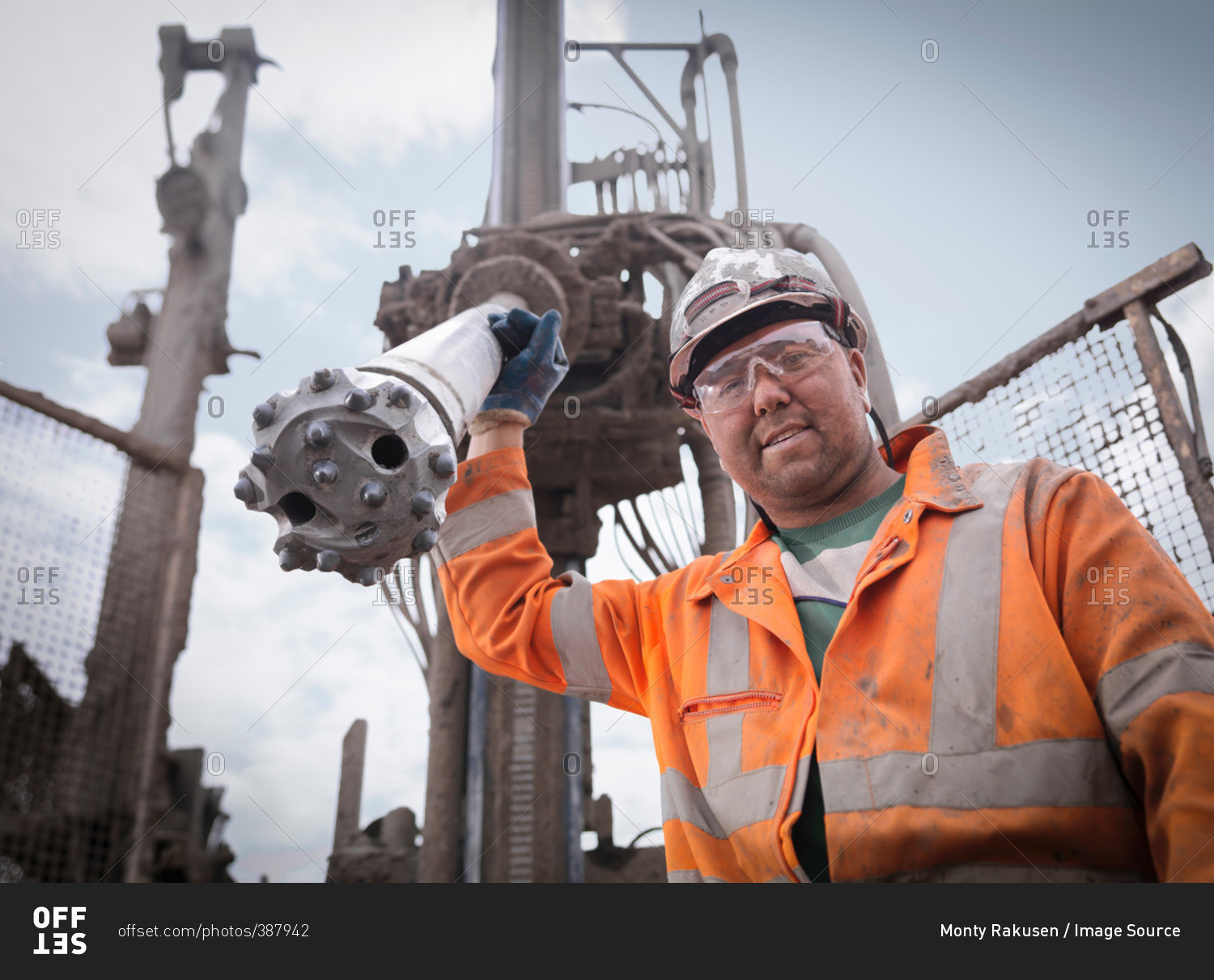 Portrait of drilling rig worker in hard hat and work wear