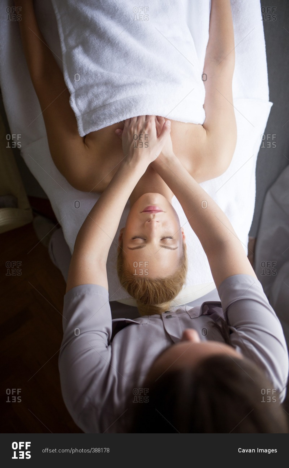 Overhead view of therapist giving massage to woman in spa