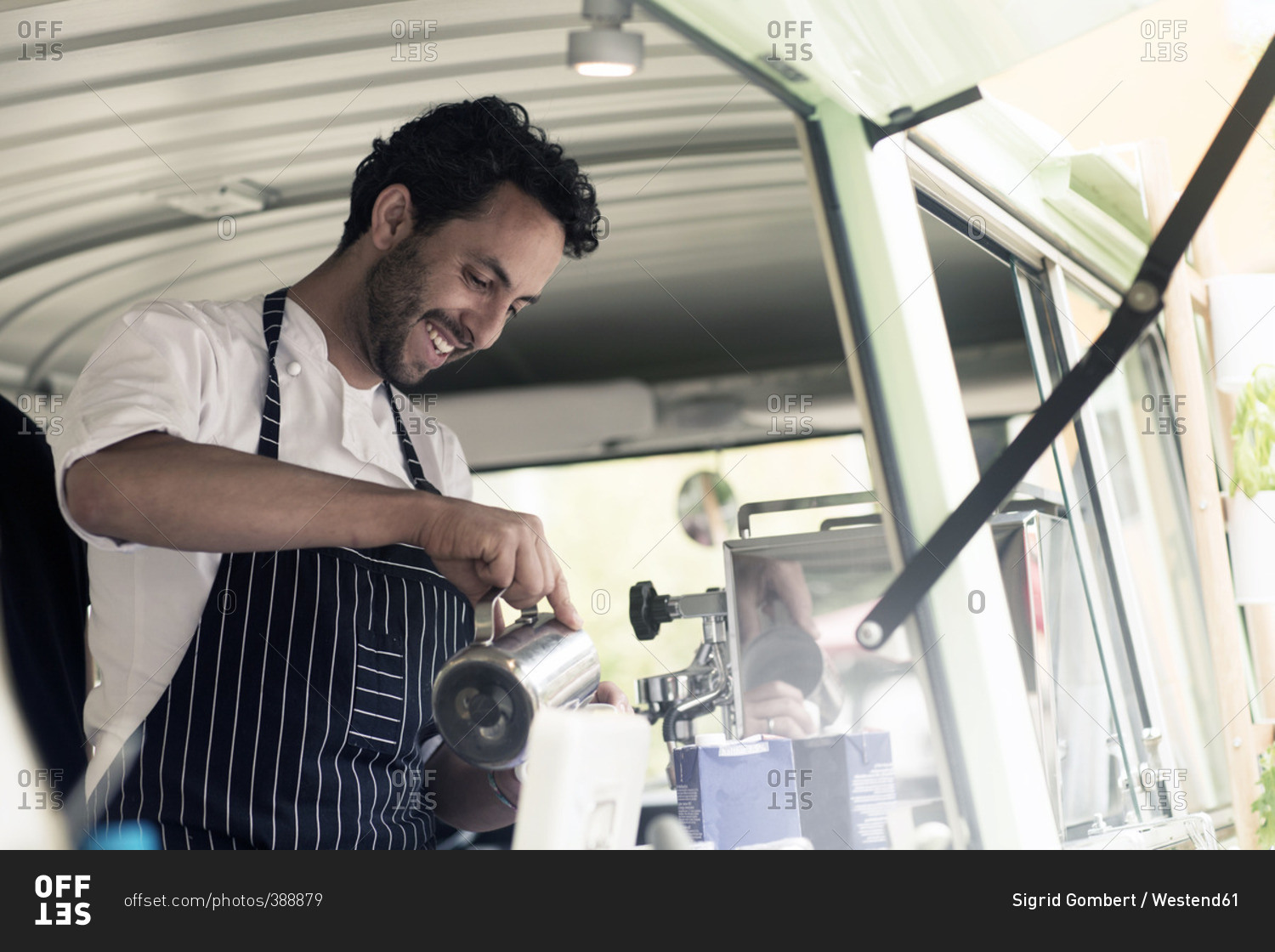 Smiling man working in a food truck