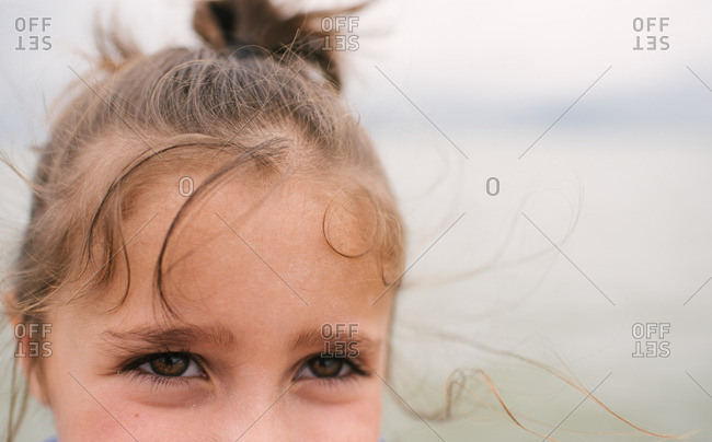 Eyes of a little girl with windblown hair