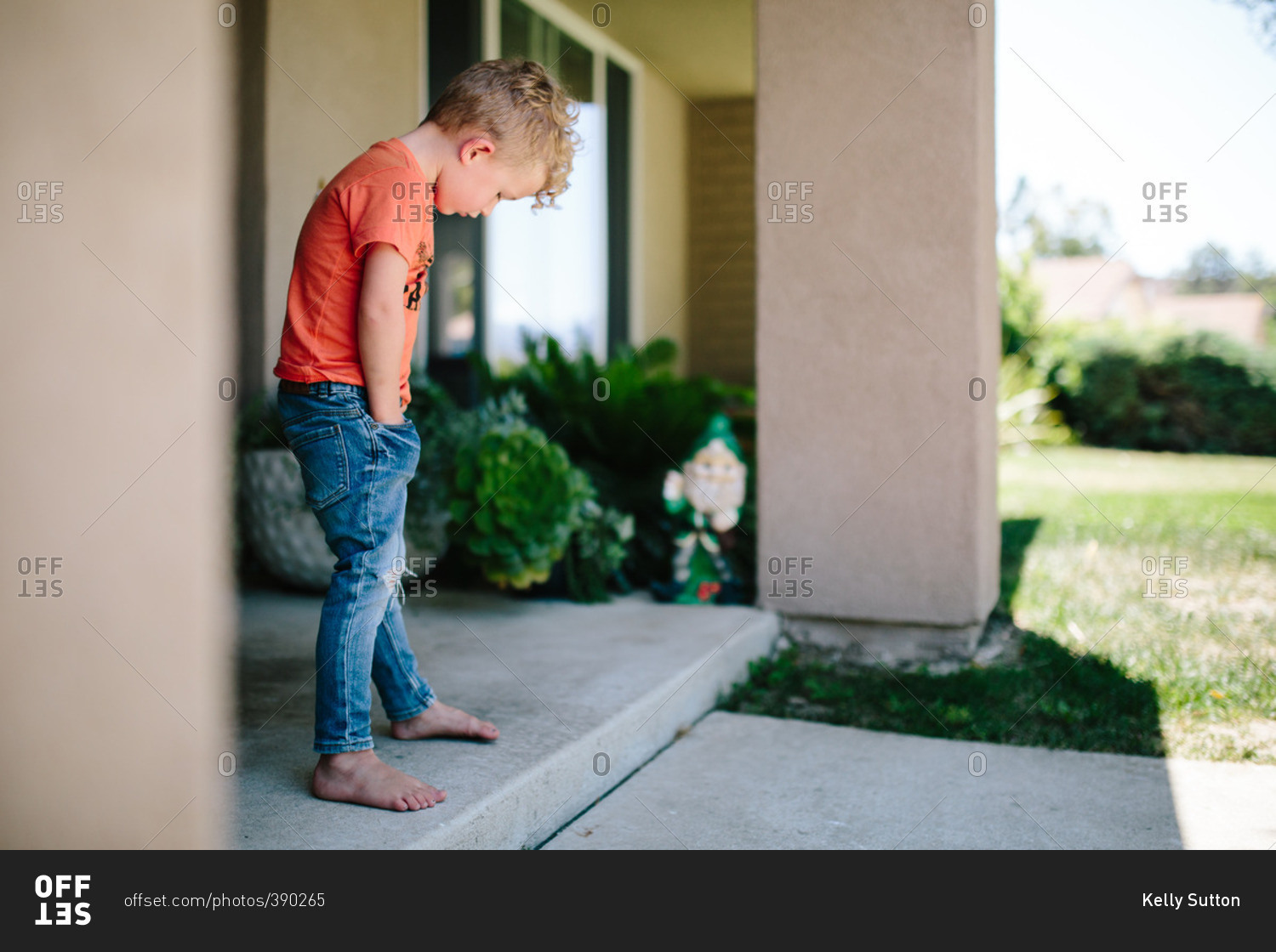 Child with hand in pocket stock photo OFFSET