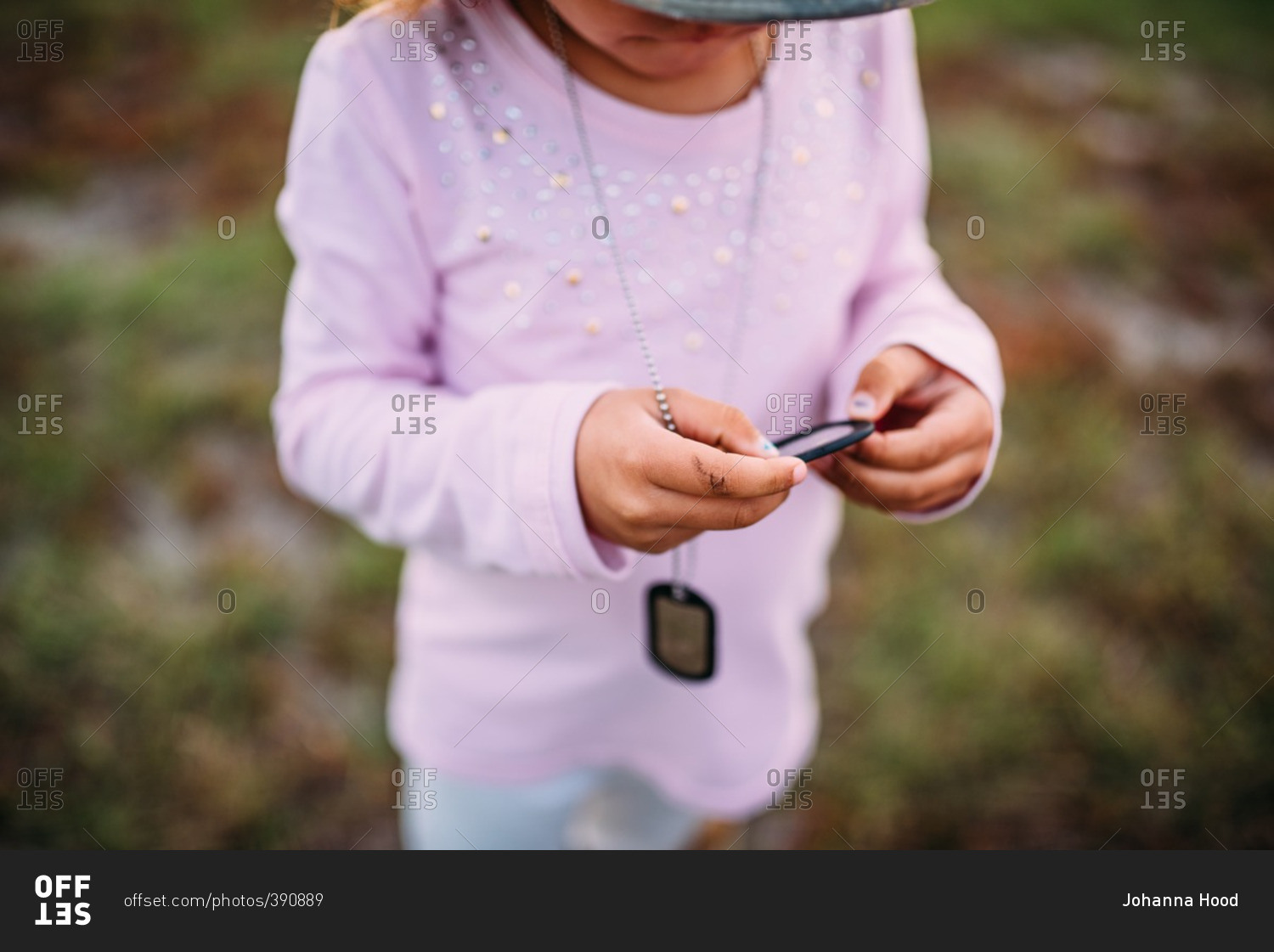 Little girl wearing military dog tags