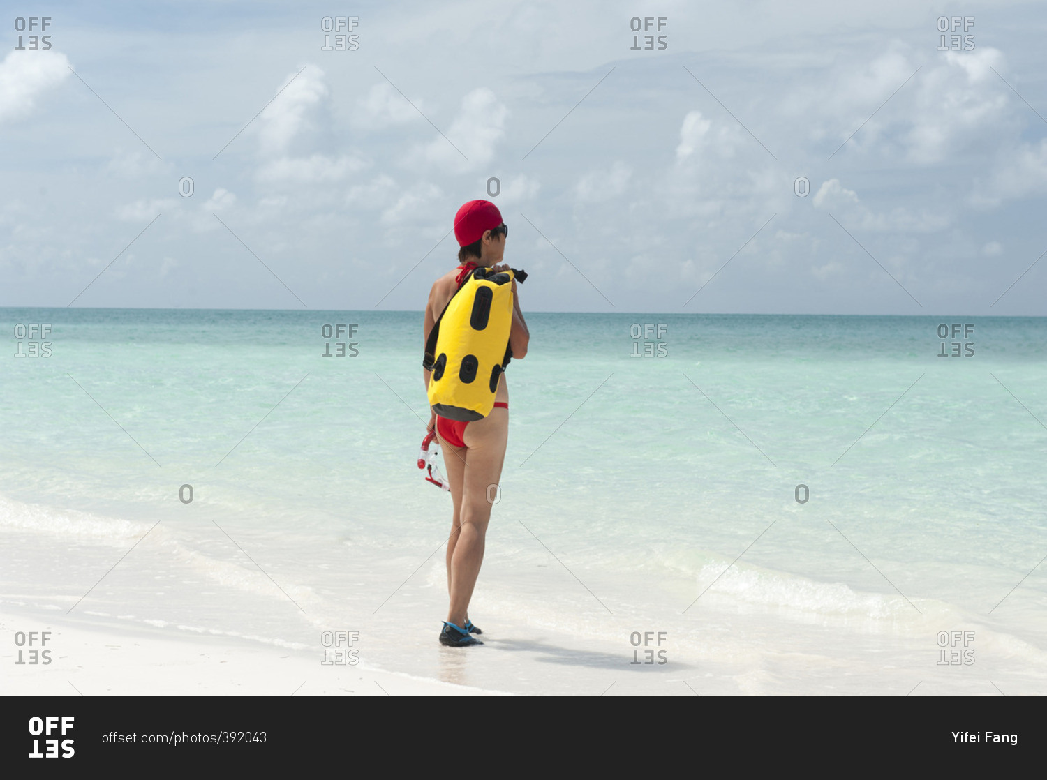 Woman with snorkeling gear entering water