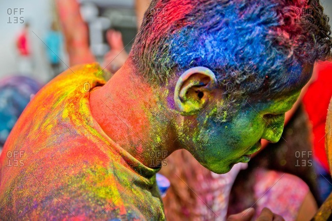 Cairo, Egypt - October 15, 2011: Man covered in bright colored powder at a color festival