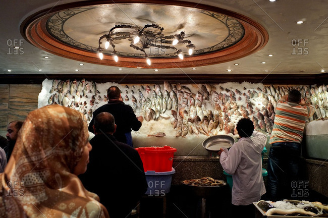 Cairo, Egypt - January 22, 2014: People selecting their fish for their meal at Kadoura fish restaurant
