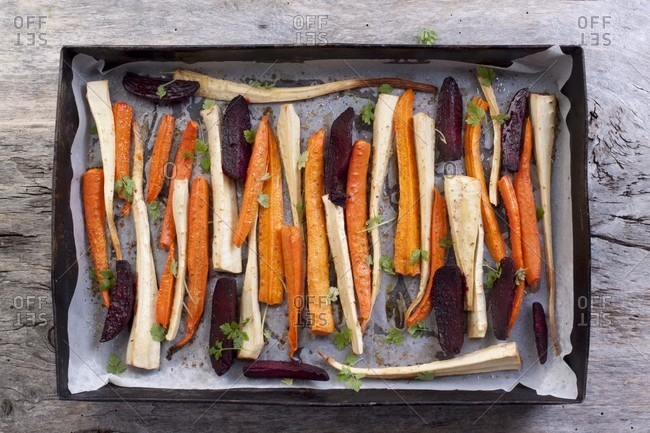 Roasted root vegetables and beetroot on a baking tray