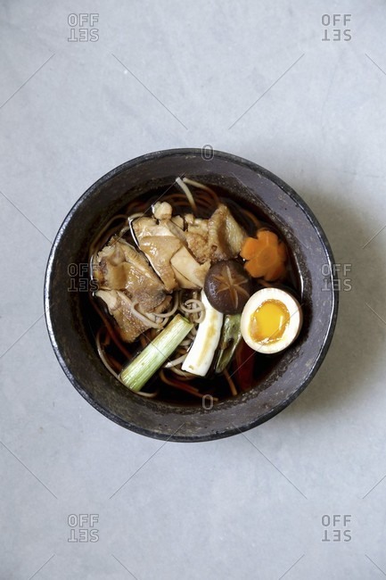 Soba noodle soup with chicken, a soft-boiled egg and spring onions