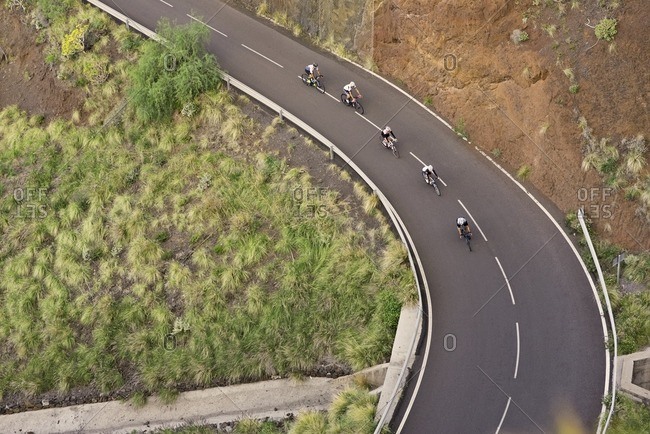 Group of cyclists descending a steep hill