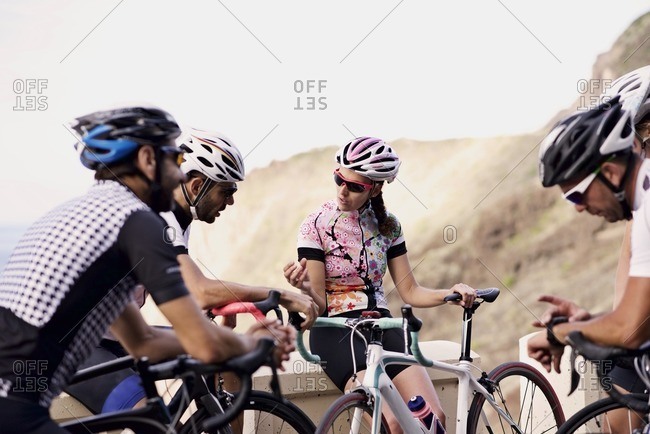 Group of cyclists taking a break along a scenic mountain overlook