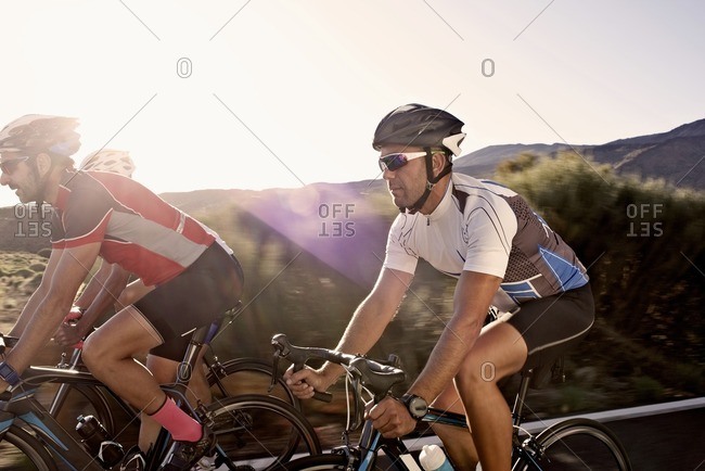 Close-up of three cyclists riding side-by-side