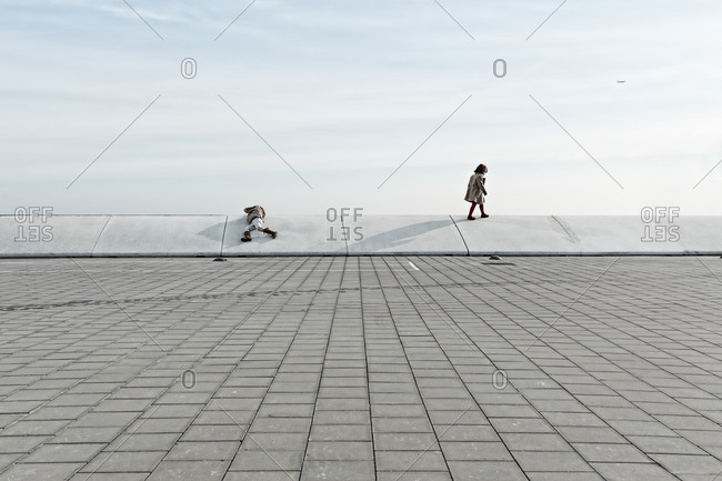 Kids on a ledge in plaza