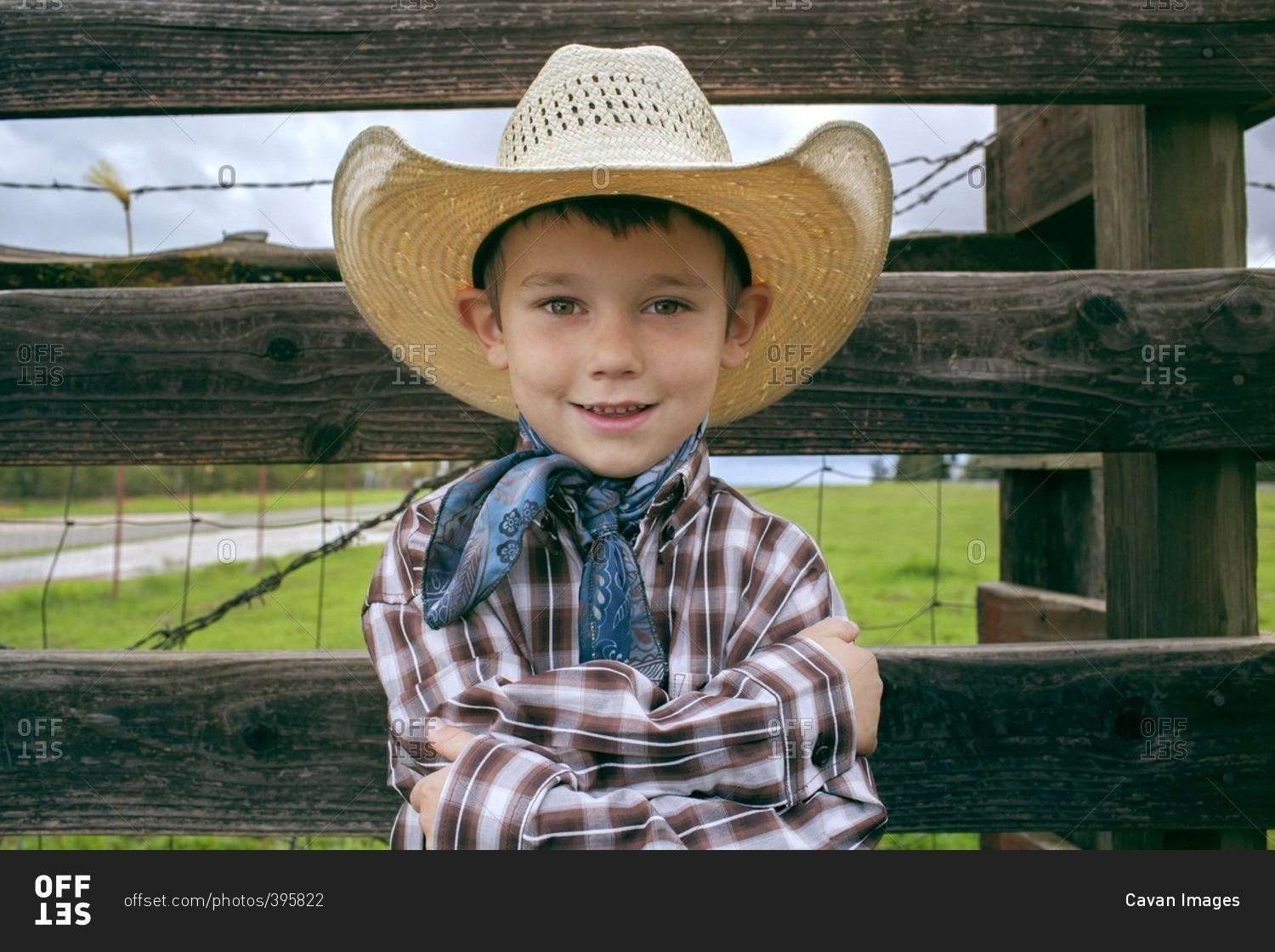 Portrait of happy boy wearing cowboy hat on field