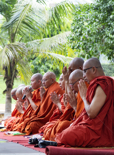October 14, 2013: Buddhist monks praying in Bodh Gaya, India