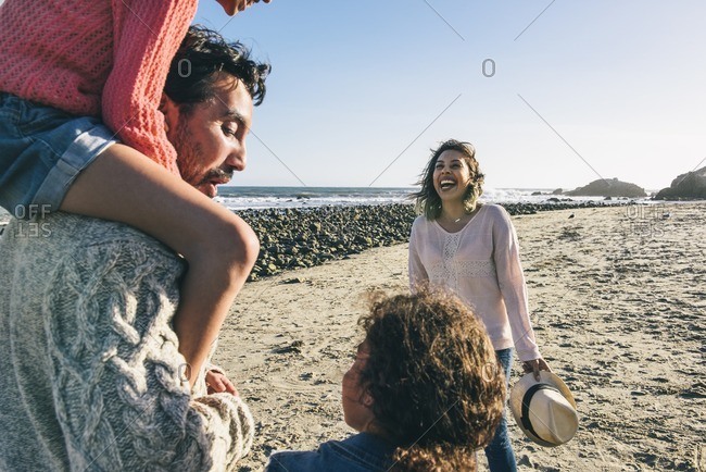 Playful family on beach in California