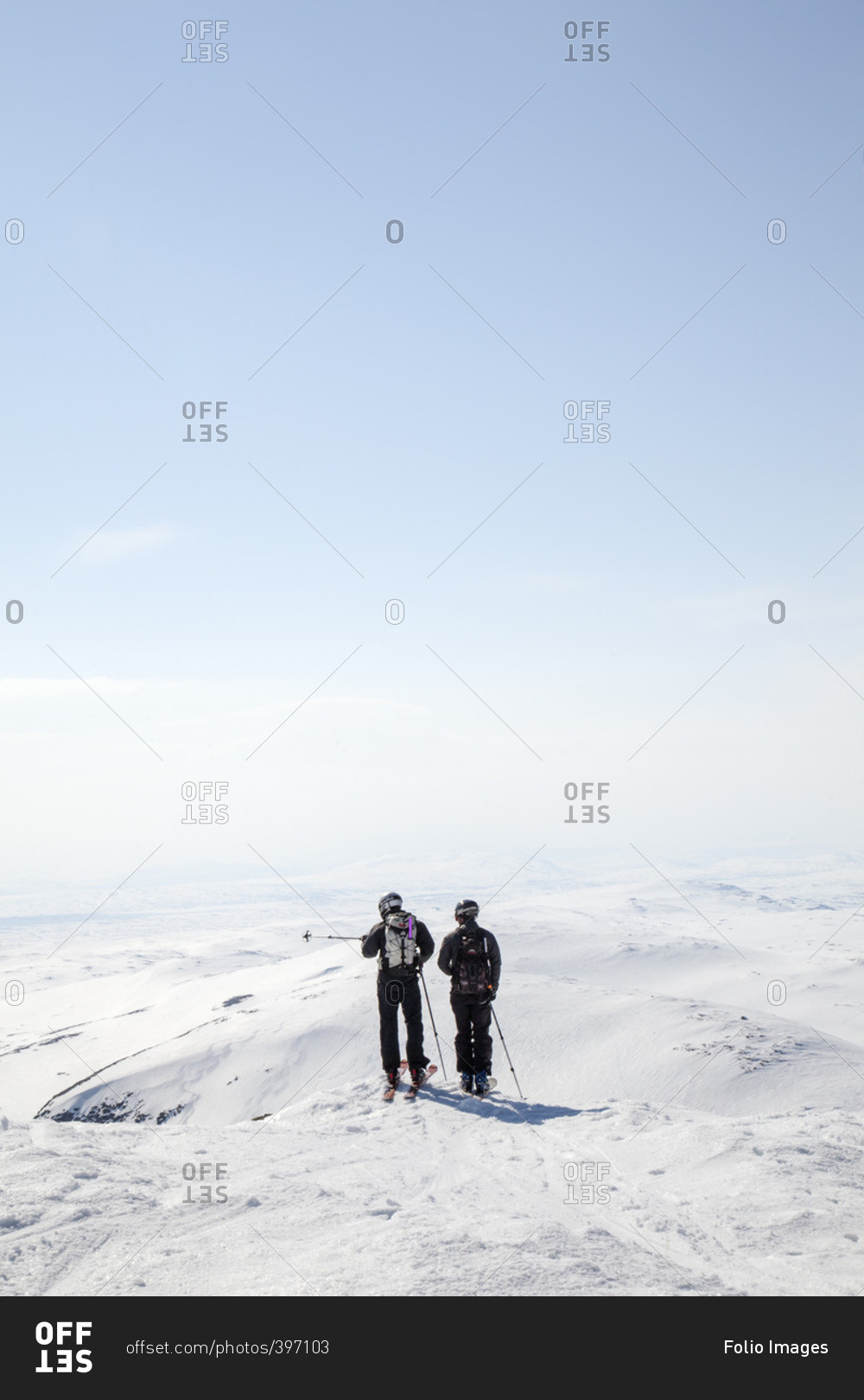 Sweden, Jamtland, Snasahogarna, Rear view of mid-adult men looking at mountains in winter