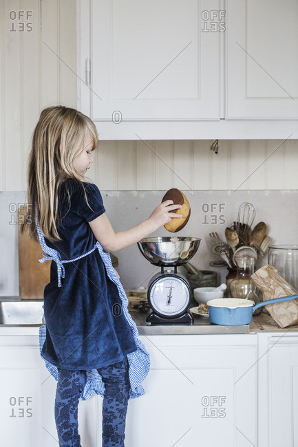 Sweden, Little girl cooking - Offset