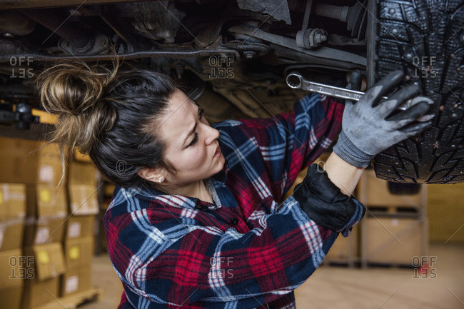 Sweden, Female mechanic adjusting wheel