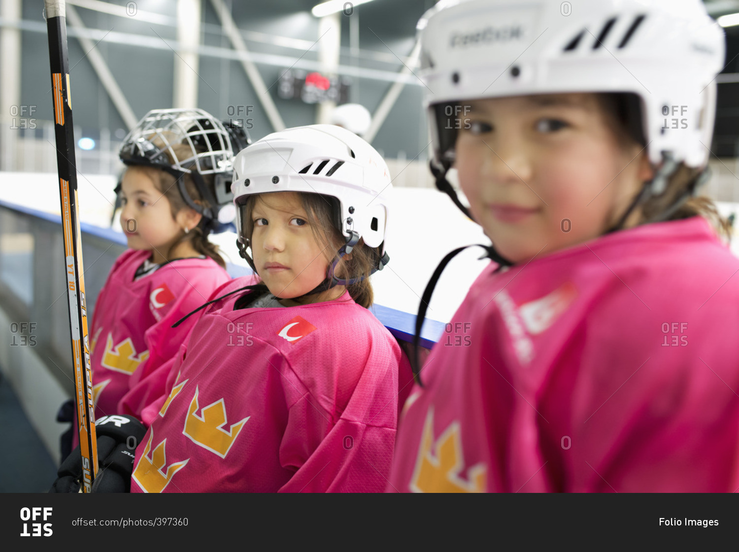 Sweden, Girls in ice hockey uniform standing by railing