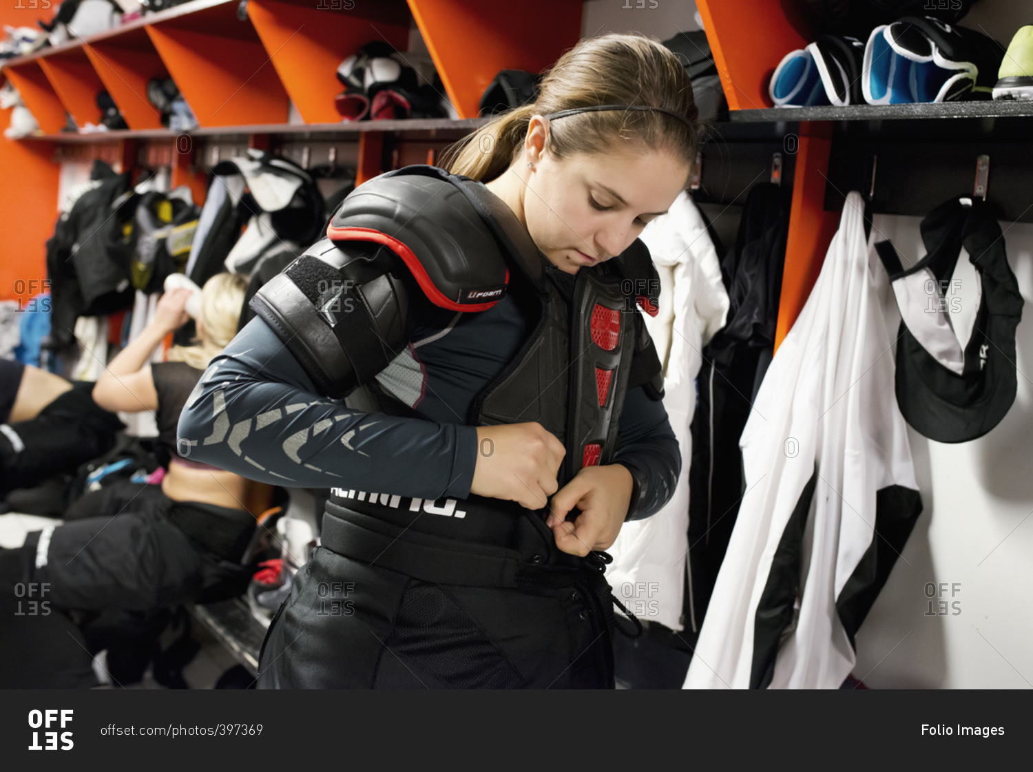 Sweden, Young ice hockey player getting ready in locker room