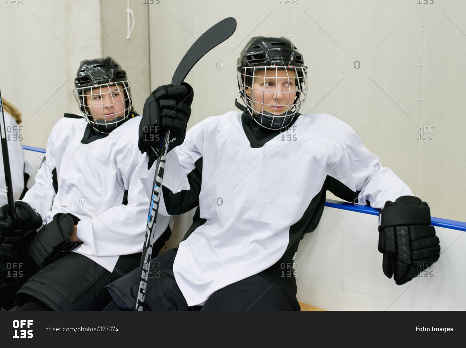 Sweden, Young ice hockey players sitting on bench waiting for game
