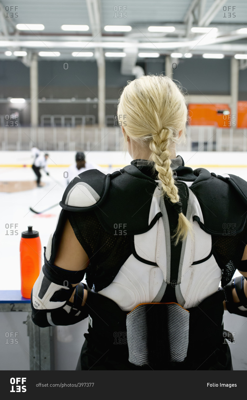 Sweden, Young ice hockey player standing by ice rink