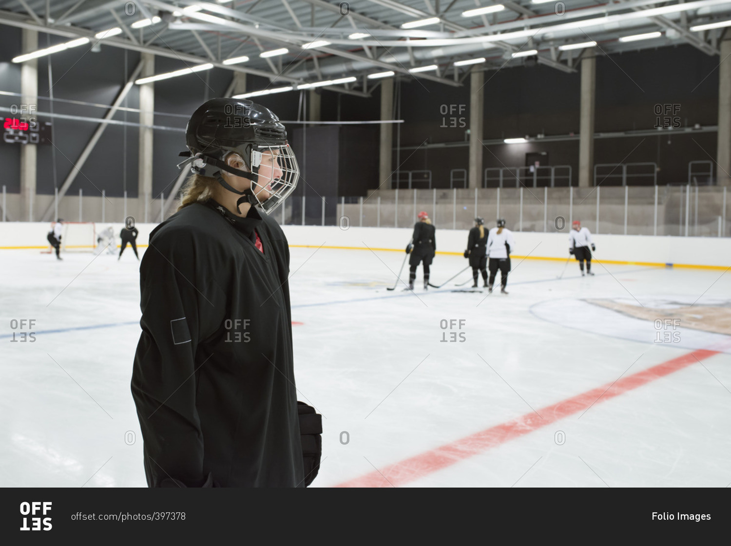 Sweden, Young hockey player wearing helmet standing on rink